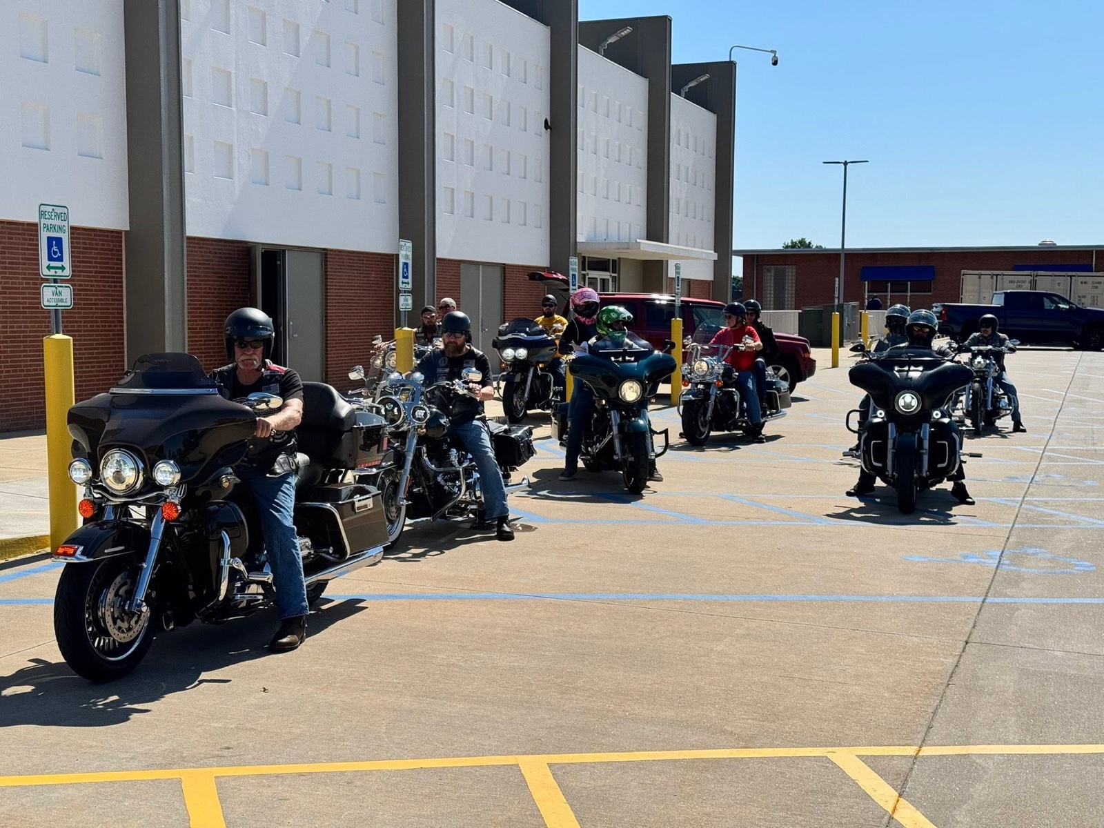 EWRC1 riders lined up on their motorcycles in a parking lot, geared up and ready to roll out on the St. Louis Union Solidarity Ride.